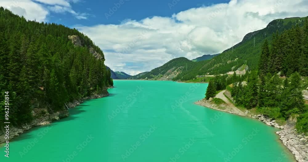 Aerial view of a beautiful Lai da Marmorera reservoir lake with turquoise water in the center of Switzerland among green mountains in summer Aerial view of a beautiful Lai da Marmorera reservoir lake with turquoise water in the center of Switzerland among green mountains in summer