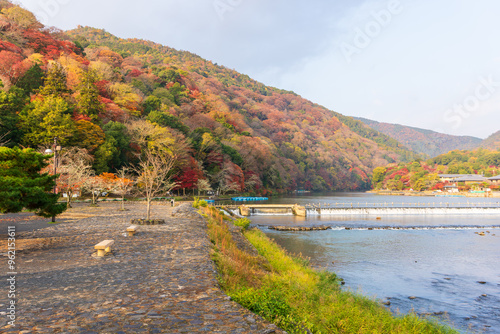 View of colorful  maple leaves in autumn season at Arashiyama and Katsura river from Togetsu or Togetsukyo bridge. Landmark and destination of Kyoto, Japan. photo