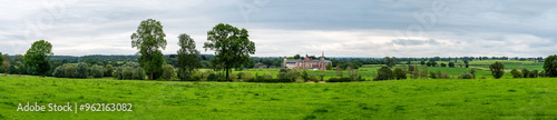 Green hills and meadows at the Belgian countryside with the Chateau Thor in the background, Lontzen, Belgium