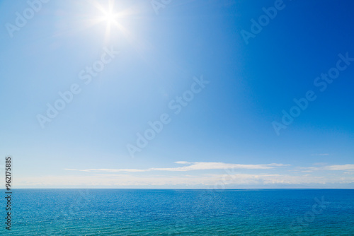 large open water surface with far snowcapped mountain range on the horizon at sunny day. photo