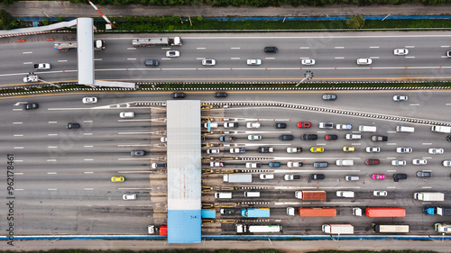 Принти на полотні Aerial view of a bustling city expressway toll gate, featuring multiple lanes filled with vehicles waiting in line for fee payment