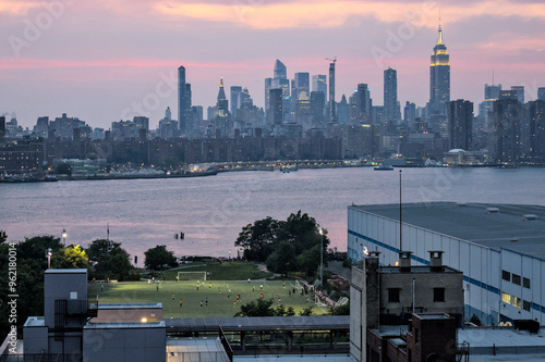BIP field with east river and nyc skyline in the background (bushwick inlet park soccer field next to a warehouse) williamsburg, greenpoint brooklyn new york city recreation sunset view
