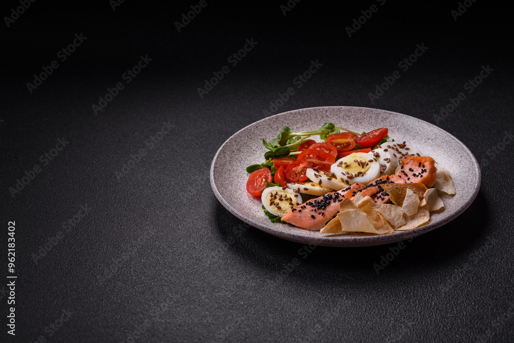Delicious fresh caesar salad with salmon, lettuce, tomatoes and egg Delicious fresh caesar salad with salmon, lettuce, tomatoes and egg