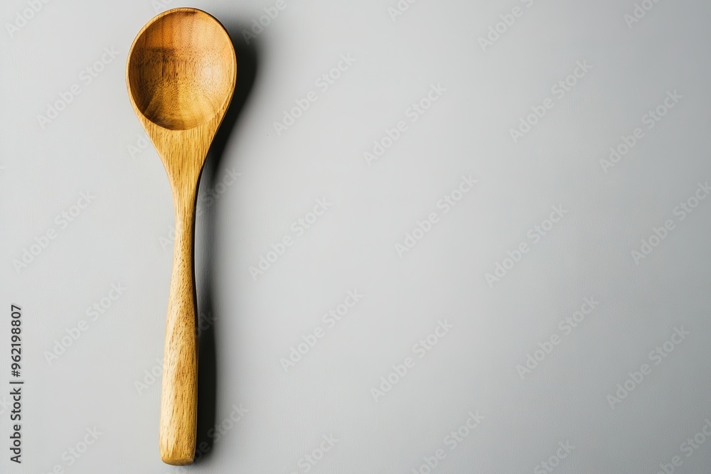 Wooden spoon on gray background, simplicity concept Wooden spoon on gray background, simplicity concept
