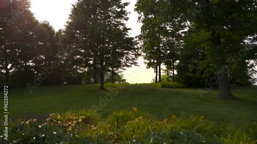 Drone shot flying though back yard over cliff to lake photo