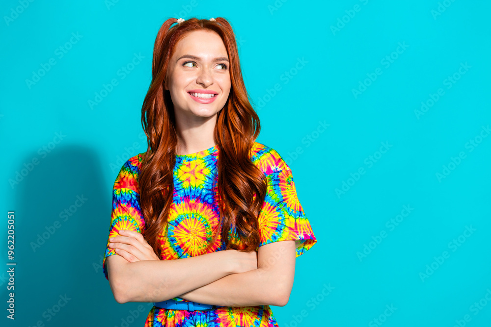 Photo portrait of pretty young girl crossed hands look empty space wear trendy colorful outfit isolated on aquamarine color background Photo portrait of pretty young girl crossed hands look empty space wear trendy colorful outfit isolated on aquamarine color background