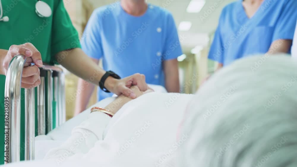 Patient on stretcher being pushed at through a hospital corridor by doctors and nurses to an emergency room. Patient on stretcher being pushed at through a hospital corridor by doctors and nurses to an emergency room.