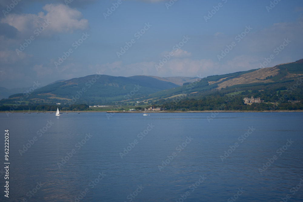 A tranquil scene with a sailboat on calm water, surrounded by mountains and fluffy clouds. A peaceful figure navigates another boat, showcasing serenity and harmony with nature. A tranquil scene with a sailboat on calm water, surrounded by mountains and fluffy clouds. A peaceful figure navigates another boat, showcasing serenity and harmony with nature.