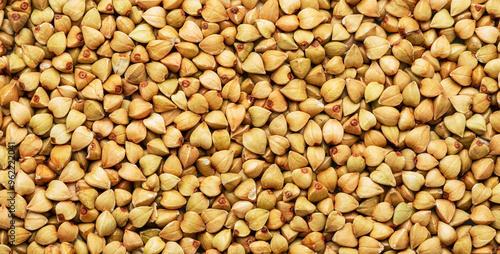 Hulled kernels of buckwheat grains close up. Food background.