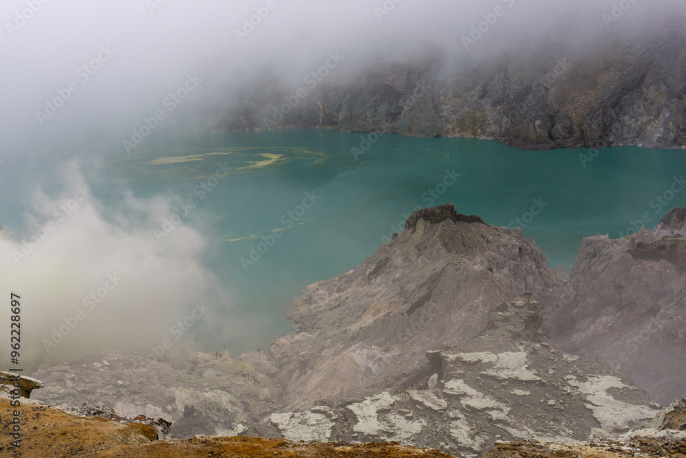 An expansive shot of an ethereal turquoise lake nestled in a mountain An expansive shot of an ethereal turquoise lake nestled in a mountain
