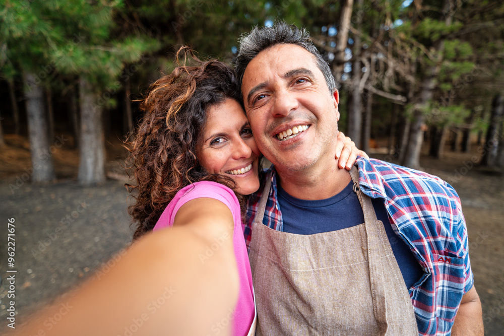 Cheerful Middle-aged Couple Taking Selfie in Forest, Happy Mature Relationship Outdoors Cheerful Middle-aged Couple Taking Selfie in Forest, Happy Mature Relationship Outdoors
