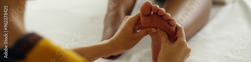 Foto Therapeutic hands giving gentle foot massage for relaxation, easing tension, and
