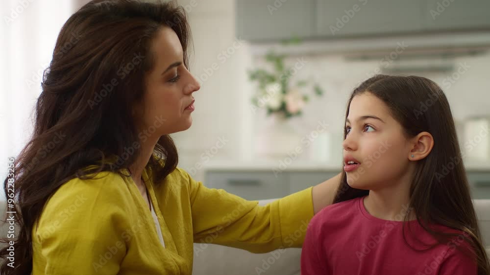 Caucasian loving mother woman female babysitter stroking head comfort listening little girl child adopted kid telling mommy daughter talking to mom indoors living room. Family motherhood relationship Caucasian loving mother woman female babysitter stroking head comfort listening little girl child adopted kid telling mommy daughter talking to mom indoors living room. Family motherhood relationship
