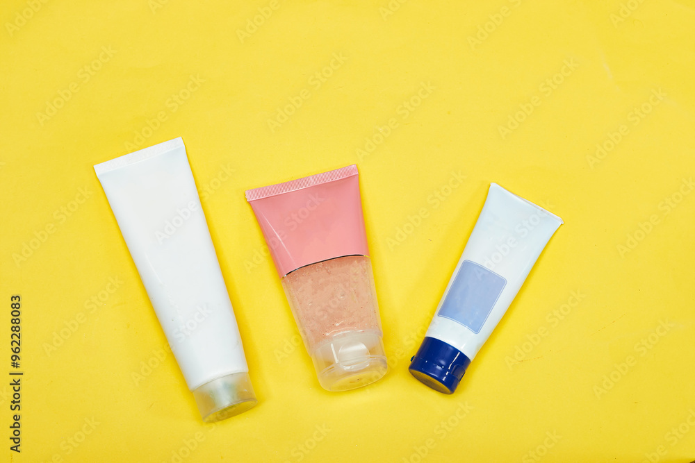 Beauty cosmetics tube; branding mock up isolated on yellow background. Package for hand cream or scrub. Beauty cosmetics tube, branding mock up Beauty cosmetics tube; branding mock up isolated on yellow background. Package for hand cream or scrub. Beauty cosmetics tube, branding mock up