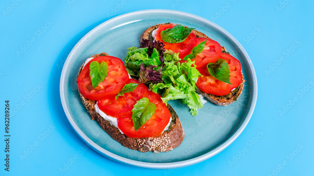 Two bruschettas with tomatoes in blue plate Two bruschettas with tomatoes in blue plate