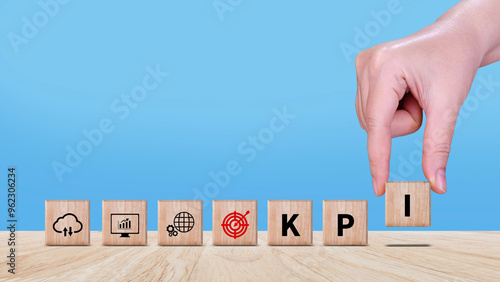 KPI text in wooden cube, Key Performance Indicator concept, Management data System KPI connected database follow earnings, Financial business data analytics graph dashboard.