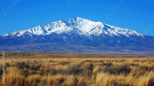 Snow-capped mountains under a clear blue sky, winter weather, cold and majestic