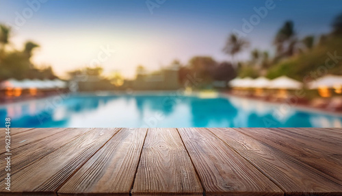 Wood table top on Beach chair in outdoor with swimming pool and sea view sea. 