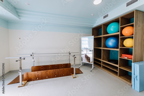 Obraz na plátně Rehabilitation equipment room with parallel bars and exercise balls for physical