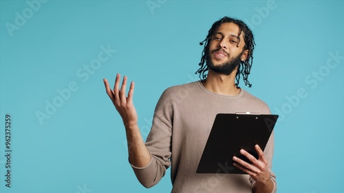Fotografie Public speaker reading from clipboard files, preparing discourse, rehearsing before doing speech