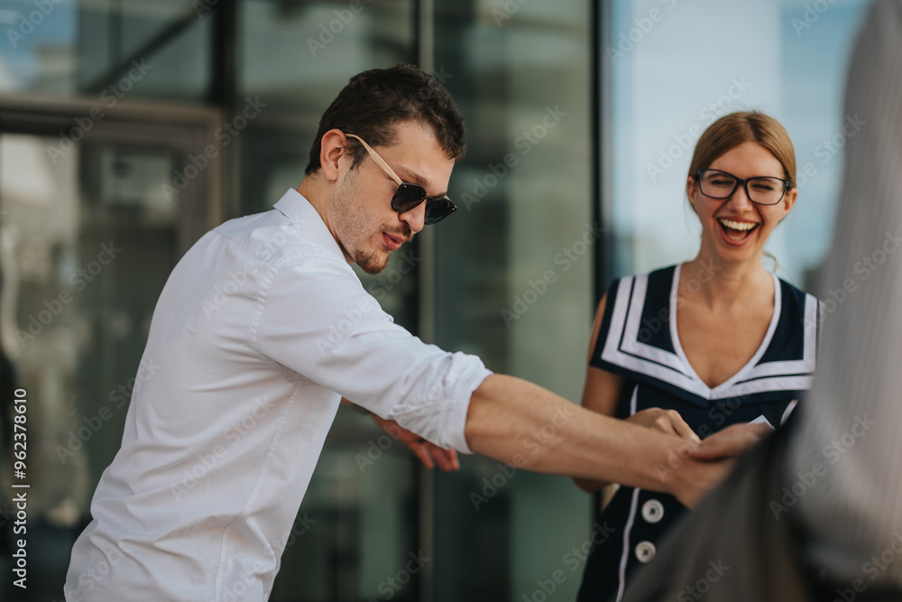 Two colleagues share a moment of laughter and fun outdoors, showcasing a joyful and friendly work environment. Two colleagues share a moment of laughter and fun outdoors, showcasing a joyful and friendly work environment.