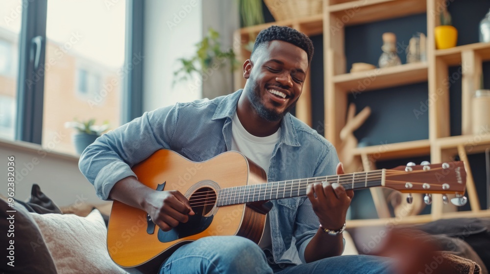 Obraz premium Joyful Musician Playing Guitar at Home