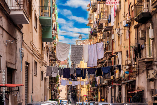Fototapeta Naklejka Na Ścianę i Meble -  city view of old down town street of slum area with vintage facades of buildings and drying clothes above old urban street