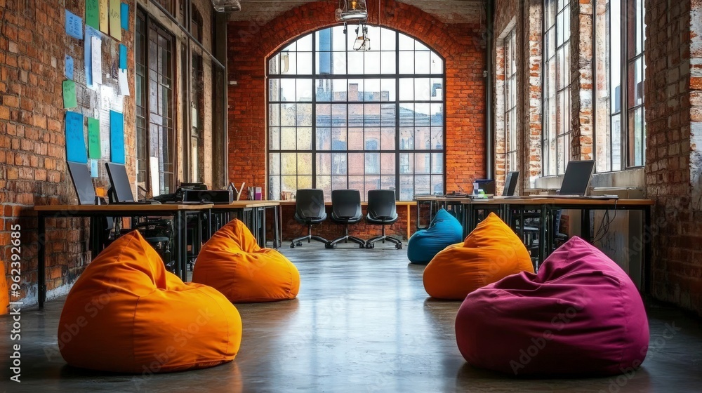 © Arti - Startup office space, open area with bean bags and desks, bright colors, natural daylight © Arti - Startup office space, open area with bean bags and desks, bright colors, natural daylight