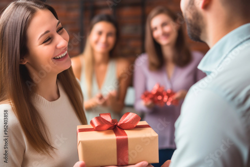 Woman giving a gift with lots of love and affection to someone photo