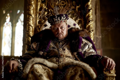 Henry VIII sitting on a throne in this fictional representation