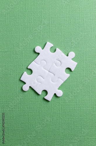 Four elements from puzzle on green background. Concept of team work, business, community and professional occupation. Vertical banner, place for text