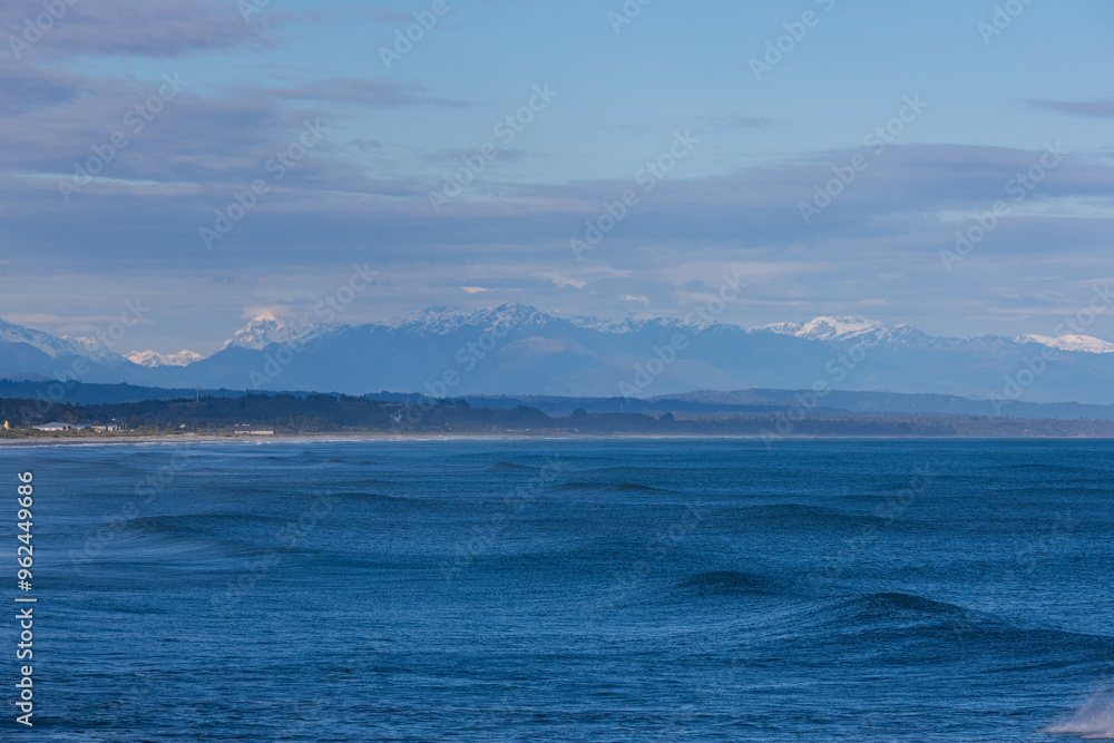 Beautiful view of wave in the ocean with Mount Cook in the background, New Zealand. Beautiful view of wave in the ocean with Mount Cook in the background, New Zealand.