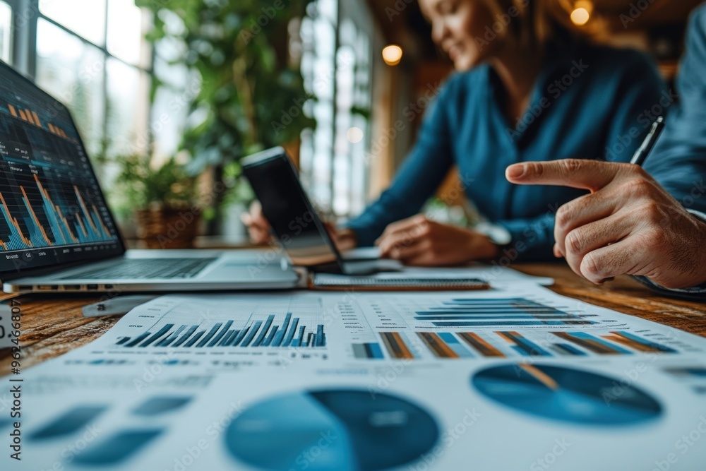 Business People Analyzing Data and Charts on Laptops Business People Analyzing Data and Charts on Laptops