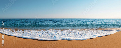 A peaceful beach with gentle waves lapping at shore, creating serene atmosphere. clear blue water meets sandy beach under bright sky. photo