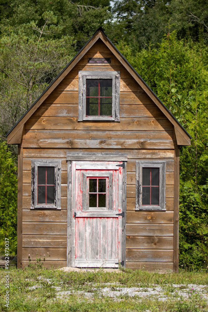 Antique wood shed with a white and red door Antique wood shed with a white and red door