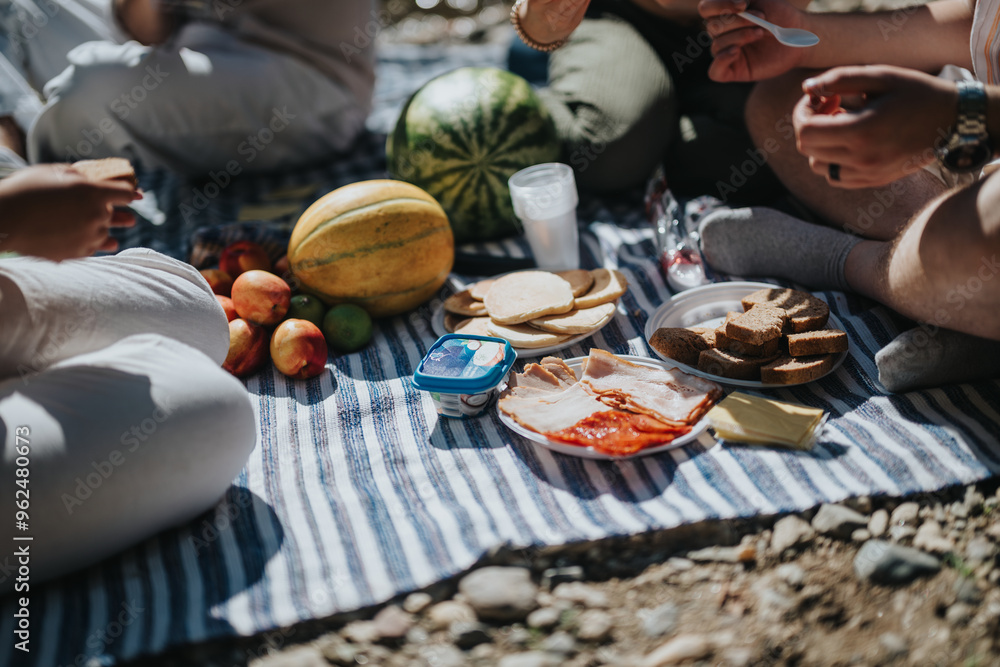 A group of friends gather for a relaxed summer picnic, sharing fresh fruits, sandwiches, and cheese on a blanket outdoors, creating a joyful and memorable experience in nature. A group of friends gather for a relaxed summer picnic, sharing fresh fruits, sandwiches, and cheese on a blanket outdoors, creating a joyful and memorable experience in nature.