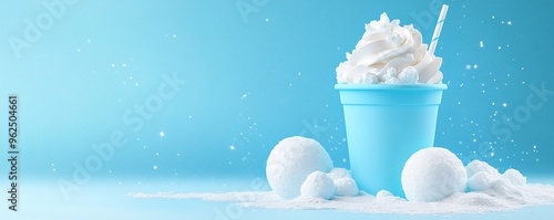 Refreshing blue dessert in a cup with whipped cream and decorative snowballs.