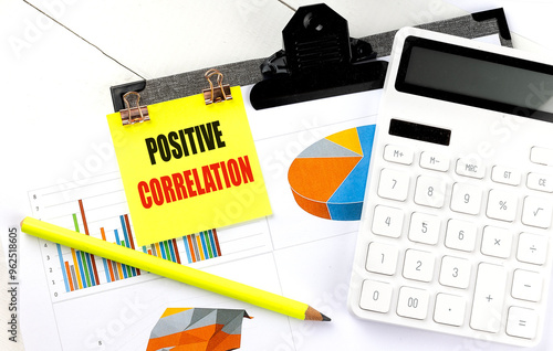 Εκτύπωση καμβά Positive correlation concept with charts, calculator, and yellow pencil on a des