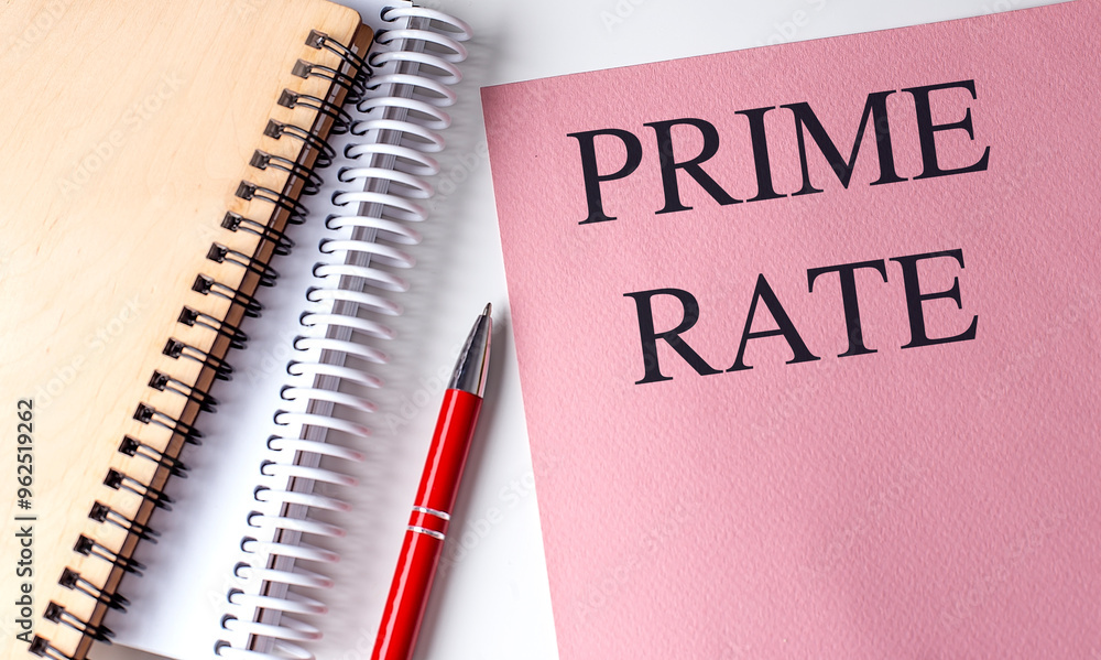 Prime rate concept with notebooks and a red pen on a white desk