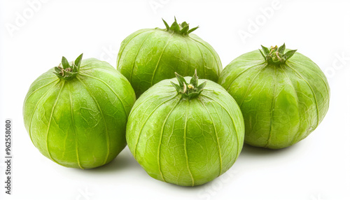 A group of four fresh tomatillos with smooth green skin, commonly used in Mexican cuisine. photo