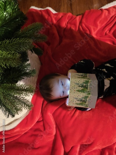 Child peering into a gift box on Christmas