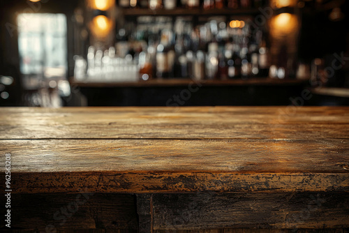 A rustic wooden bar top with a blurred background of bottles, creating a cozy atmosphere for socializing.