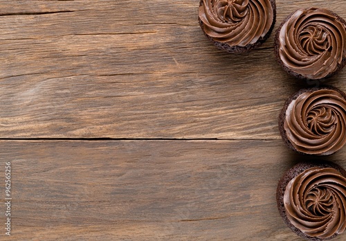 Delicious chocolate cupcakes on wooden background