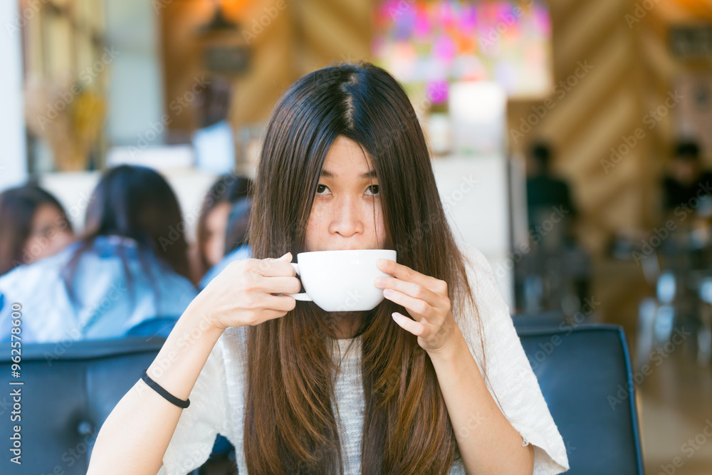 Happy asian female with latte coffee in cafe during free time Happy asian female with latte coffee in cafe during free time