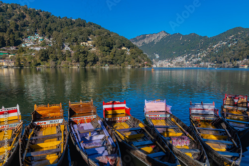 Boats tied at the banks of the famous Naini lake in Nainital, a preferred summer tourist in India. Clicked on 2 January 2022.
 photo