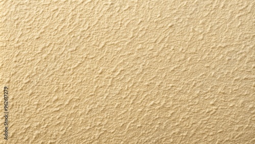 Close-up of a textured beige surface with fine details and subtle color variations