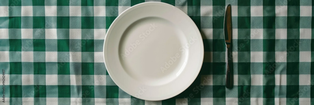 A food arrangement on a white plate set on a green checkered tablecloth. A food arrangement on a white plate set on a green checkered tablecloth.