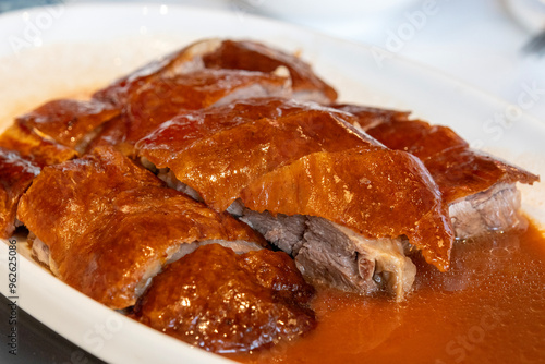 Photography Delicious roasted golden goose is cut into pieces and placed on a plate