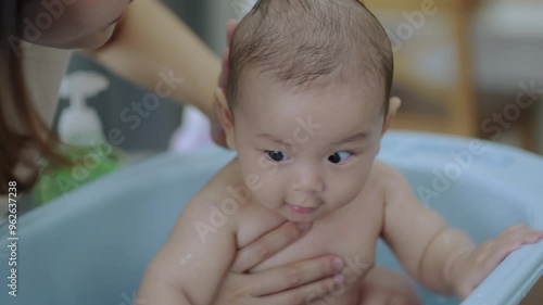 Young mom shower baby , Baby asian happy moment with mom at living room. asian family with newborn
