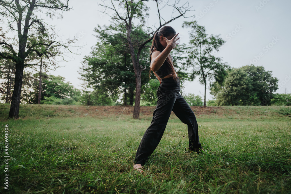 A young girl dancing in a park, expressing joy and freedom amidst the natural beauty of tall trees and lush greenery. A young girl dancing in a park, expressing joy and freedom amidst the natural beauty of tall trees and lush greenery.